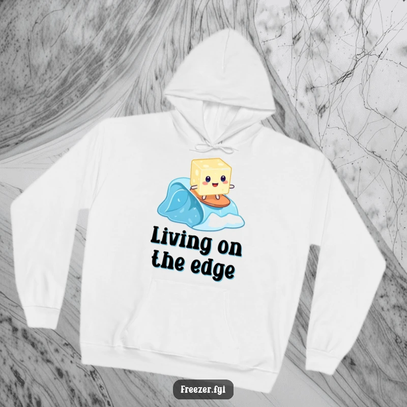 Funny hoodie with a wobbly jelly cube surfing on a tiny frozen wave, warm and humorous.