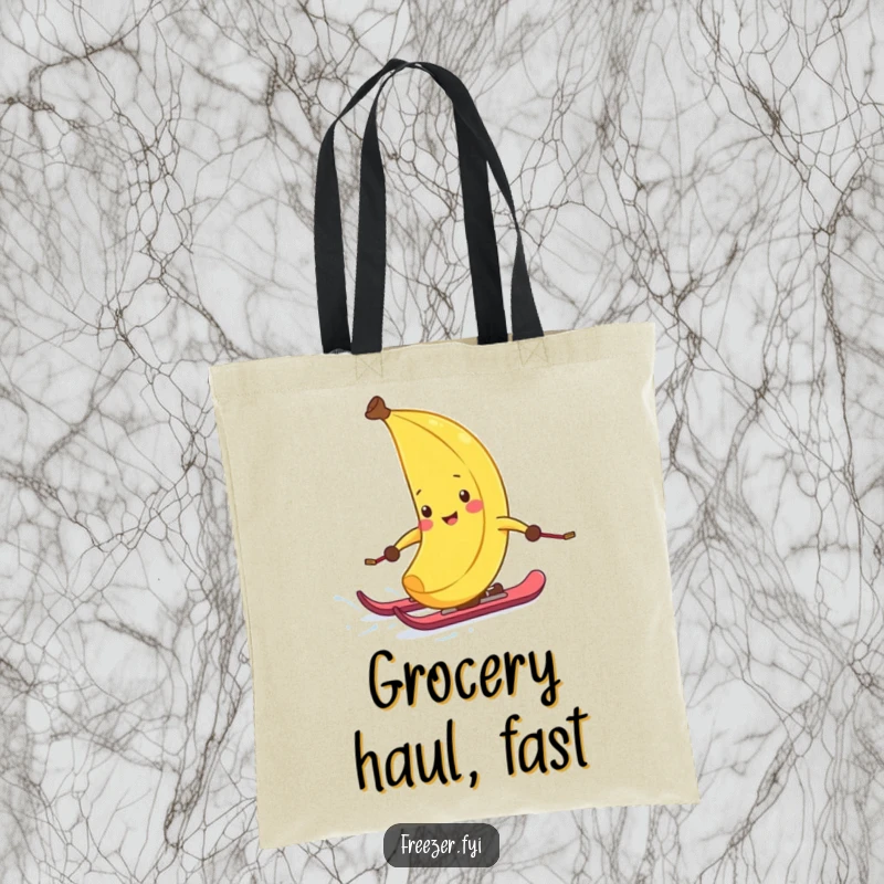 Funny tote bag featuring a giggling banana peel with tiny skis, hilariously descending a snowy slope, practical for errands and fun.